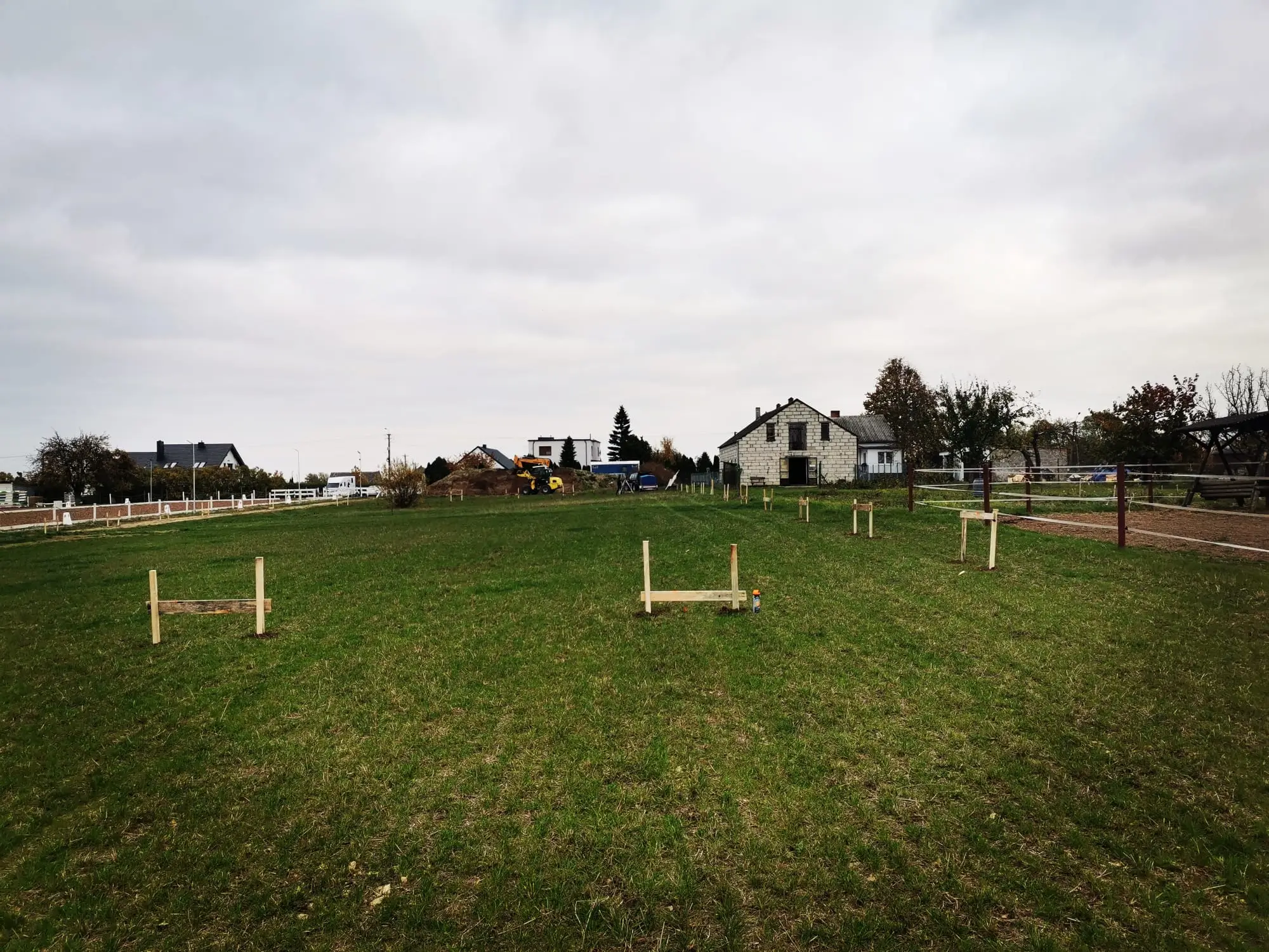 A diverse group of business professionals proudly holding up a certificate in a well-lit office setting.