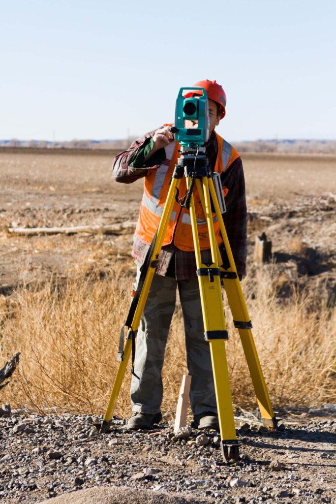 A man and woman examining a blueprint together, discussing plans and ideas for a construction project.